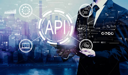 API - application programming interface concept API concept with businessman holding a tablet computer