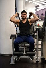Fototapeta na wymiar male athlete goes in for sports in the gym