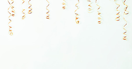 Gold serpentine isolated on light background, banner. Holiday decoration for parties, birthday,...