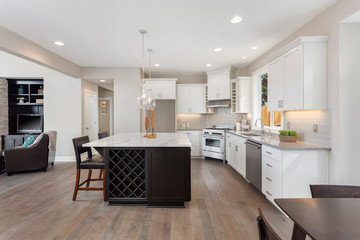 Kitchen interior in new luxury home with large island and stainless steel appliances