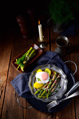 delicious green asparagus wrapped in bacon and egg
