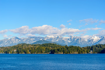 Fantastic view over ocean, snow mountain and rocks at Sechelt inlet in Vancouver, Canada.