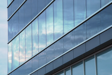 Fototapeta na wymiar sky reflections on glass building windows mirror office skyscraper