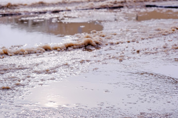 Paved road covered with melting snow