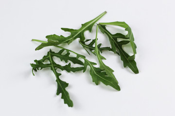 fresh rucola leaves isolated on white background.