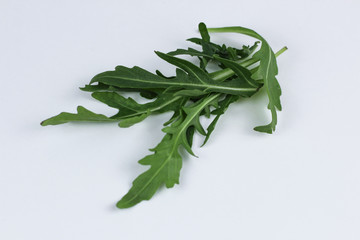 fresh rucola leaves isolated on white background
