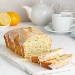 Lemon bread coated with sugar sweet icing and sprinkled with lemon peel. Slice of cake with citrus