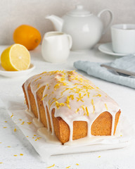 Lemon bread coated with sugar sweet. Cake with citrus, Whole loaf, side view, close up, vertical