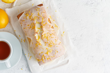 Lemon bread coated with sugar sweet icing and sprinkled with lemon peel. Cake citrus, copy space