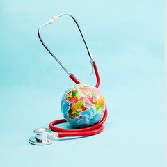 Red Stethoscope on bright pastel blue background