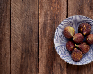 figs on plate on wooden table background