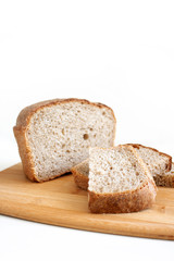 Rye and wheat bread. A piece of bread. A loaf of bread on a cutting board. Isolated image. Food