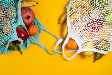 Zero waste plastic free concept. Fresh fruit in a mesh net bag, top view with copyspace