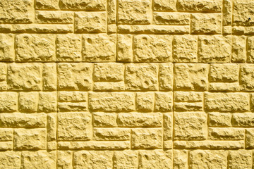 close up of decorative yellow tiles pasted on the wall
