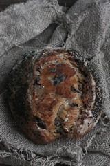 Fresh bread with raisins in hand macro
