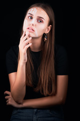 Art portrait of a beautiful girl in white paint.