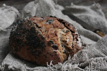Fresh bread with raisins in hand macro