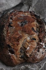 Fresh bread with raisins in hand macro