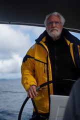 White bearded sailing senior, experienced skipper on a sailboat