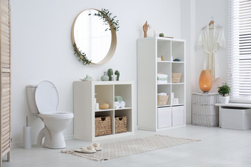 Interior of modern bathroom with round mirror