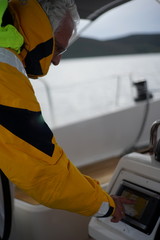 White bearded sailing senior, experienced skipper on a sailboat