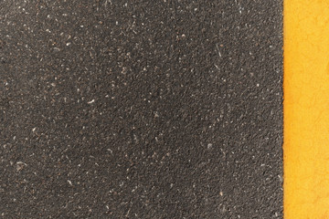 Black asphalt road texture with marking background. Double yellow line on asphalt road.