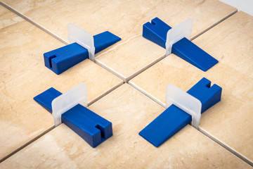 Tile levelling system with plastic clips and wedges.