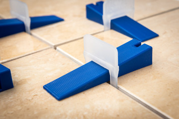 Tile levelling system with plastic clips and wedges.