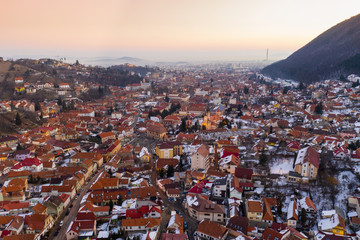 Obraz premium Aerial drone shot of Brasov old town at sunrise on a beautiful winter morning