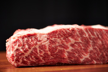 Fresh raw steak beef on black background 