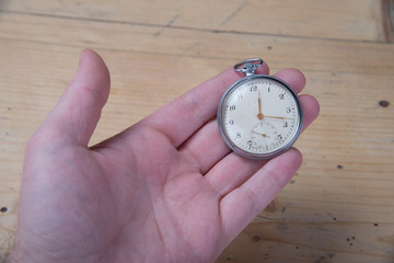 Old pocket watch in hand