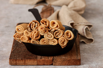Traditional Ukrainian or Russian pancakes.Stack of pancakes on a cast-iron frying pan