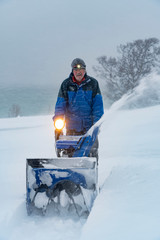 facility manager riding a snowblower in a heavy blizzard in northern Norway