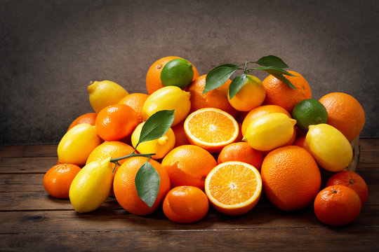 mix of fresh citrus fruits on a wooden table © Nitr