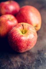 Close-up apples on the rustic wooden background. Selective focus. Shallow depth of field.
