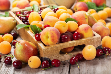 Naklejka na ściany i meble fresh ripe fruits in a wooden box