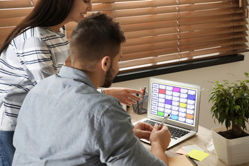 Fototapeta na wymiar Colleagues working with calendar app on laptop in office