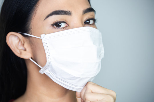 A Woman Wearing Medical Disposable Mask To Avoid Contagious Viruses.