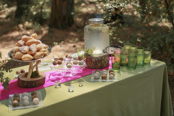 Festive wedding table, decorated with sweets and drinks.