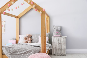Stylish child room interior with comfortable bed
