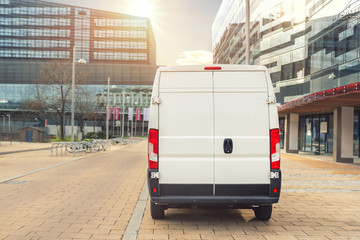 Small cargo delivery van driving in european city central district. Medium lorry minivan courier...