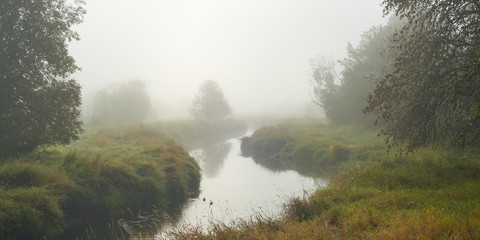Fototapeta na wymiar Panoramic misty morning view with Salmon Creek in Vancouver, Washington state.