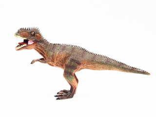 Tyrannosaur rubber toy isolated on white © Y