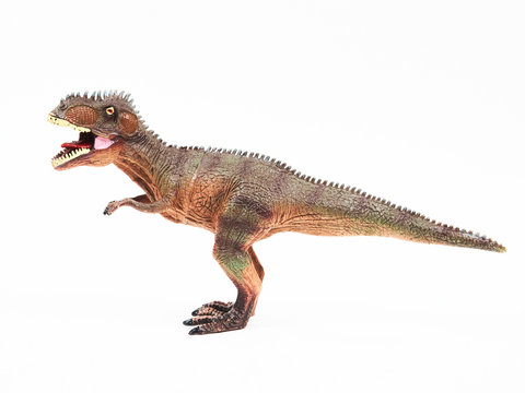 Tyrannosaur rubber toy isolated on white