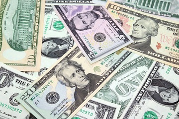 American paper money background. Mix of American dollars bills in denominations of 1, 5, 10 and 20 close up.
