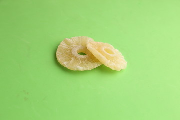 piece of dried pineapple fruit in color background