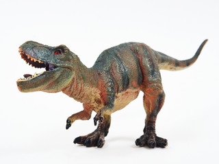 Tyrannosaur rubber toy isolated on white © Y