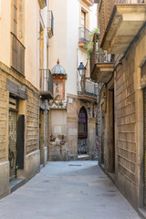 Obraz na płótnie Canvas Old narrow street in Gothic Quarter. Barcelona, Spain. Spanish elegant old town urban alley.