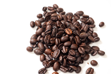 A handful of coffee beans on a white background