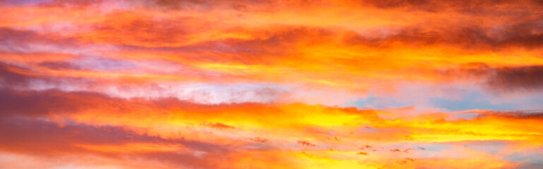 Panorama of colorful x clouds in the sunset sky
